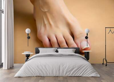 Closeup view of woman`s groomed foot after care procedure on beige background Wall mural